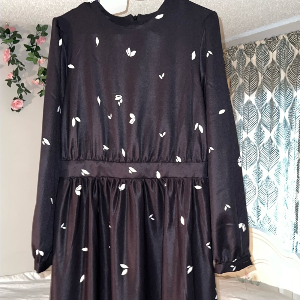 A long sleeve black and white formal dress.